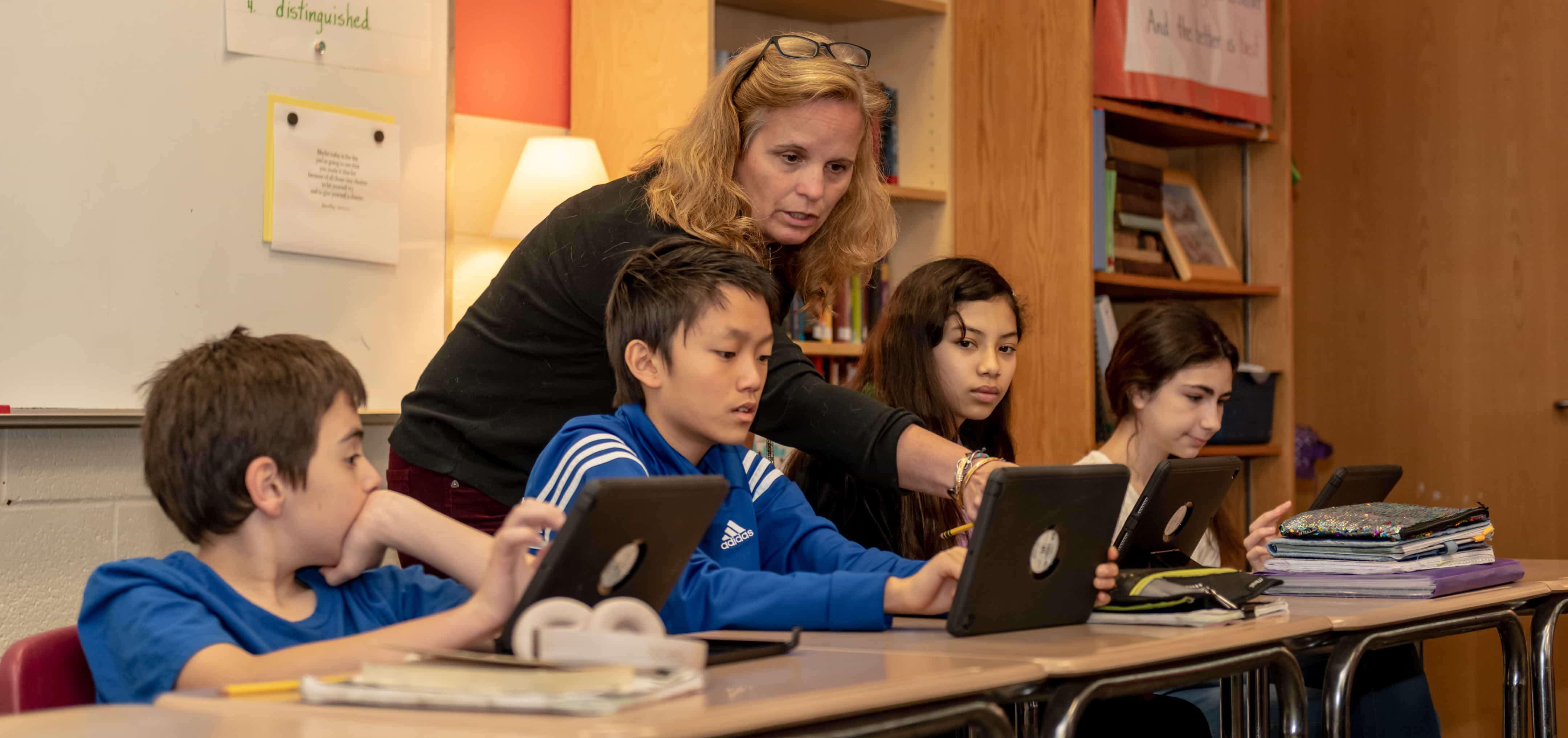 Patty assisting students with their Membean training.